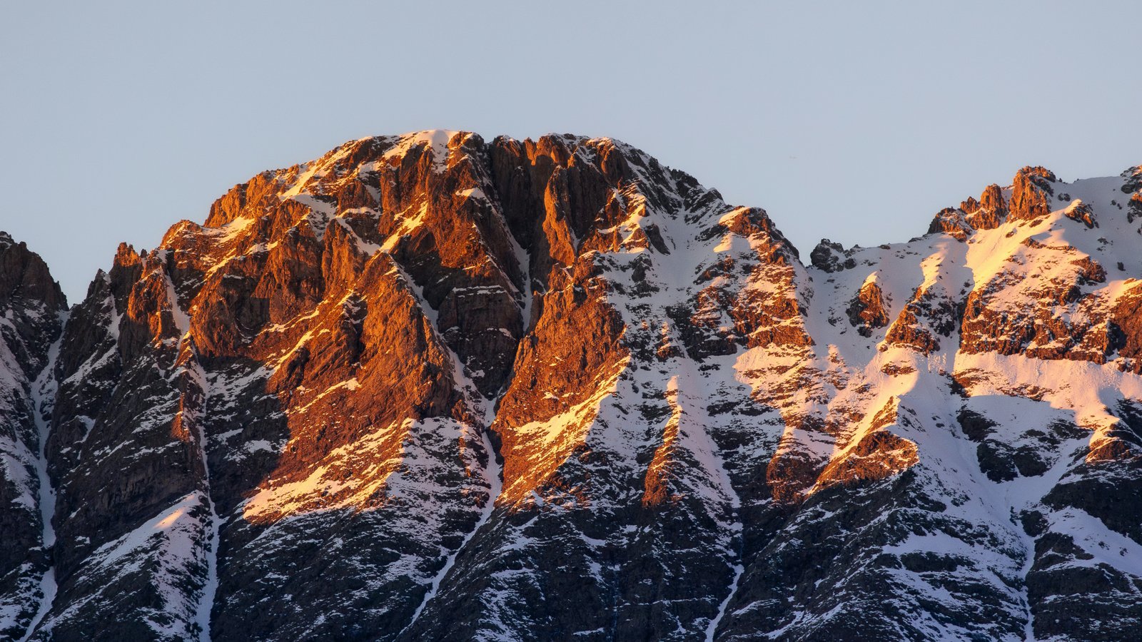 Snow-capped Pyrenees peak bathed in sunset light