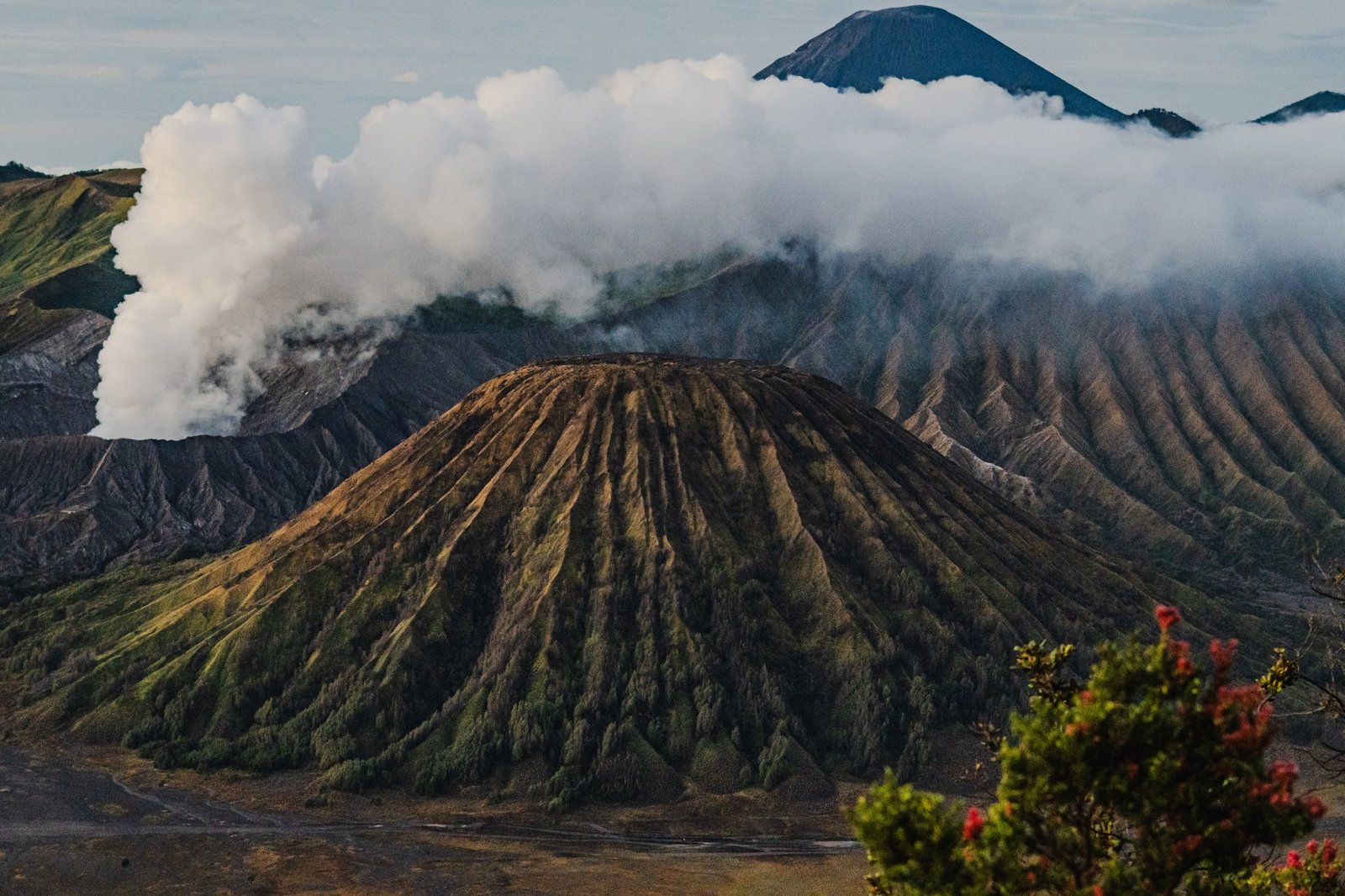 Mount Batok and Bromo's steaming crater with Semeru above the cloud. Bromo Tengger Semeru National Park, East Java.