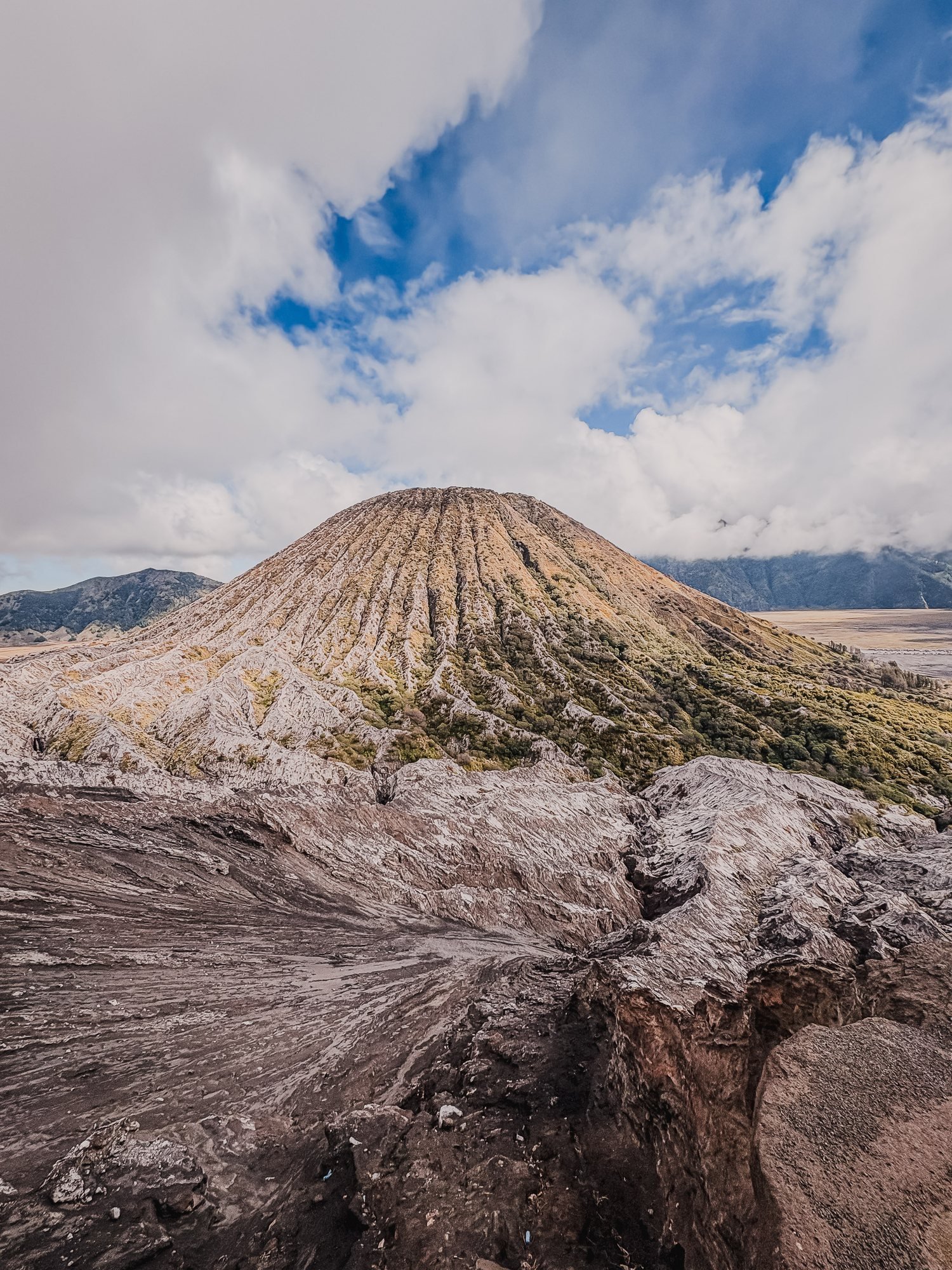 Batok and the Sand Sea from the rim of the crater. Rock and ash in the foreground.