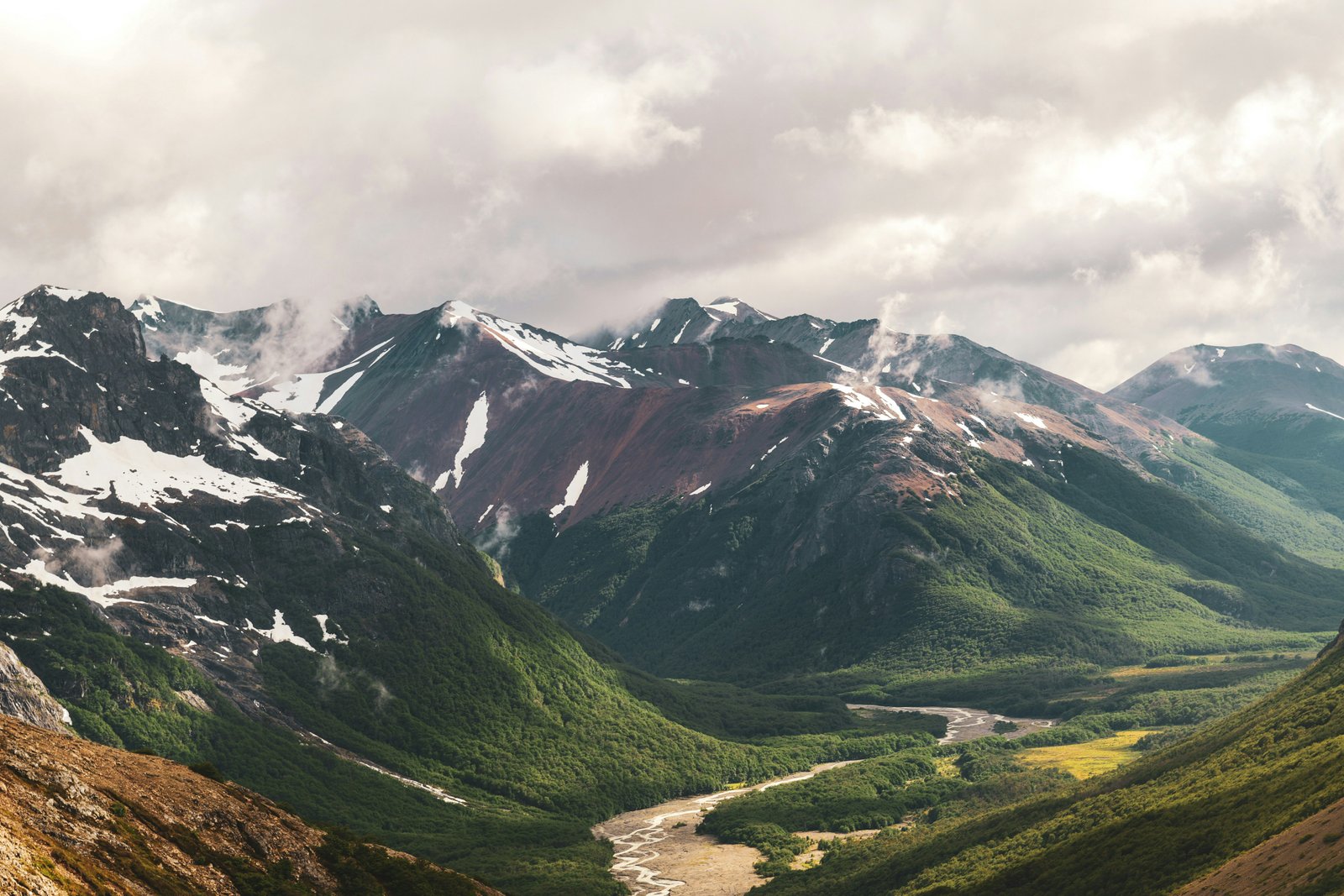 Wide valley view with snow-streaked ridgelines and lenga beech