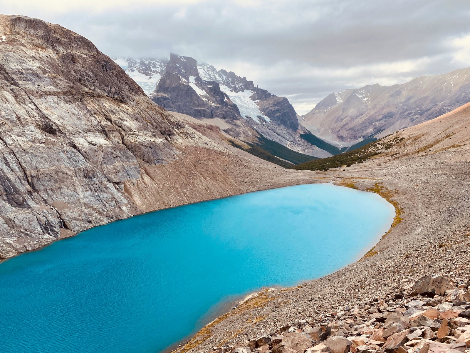 Laguna Cerro Castillo, a turquoise glacial lake curving below the castle spires
