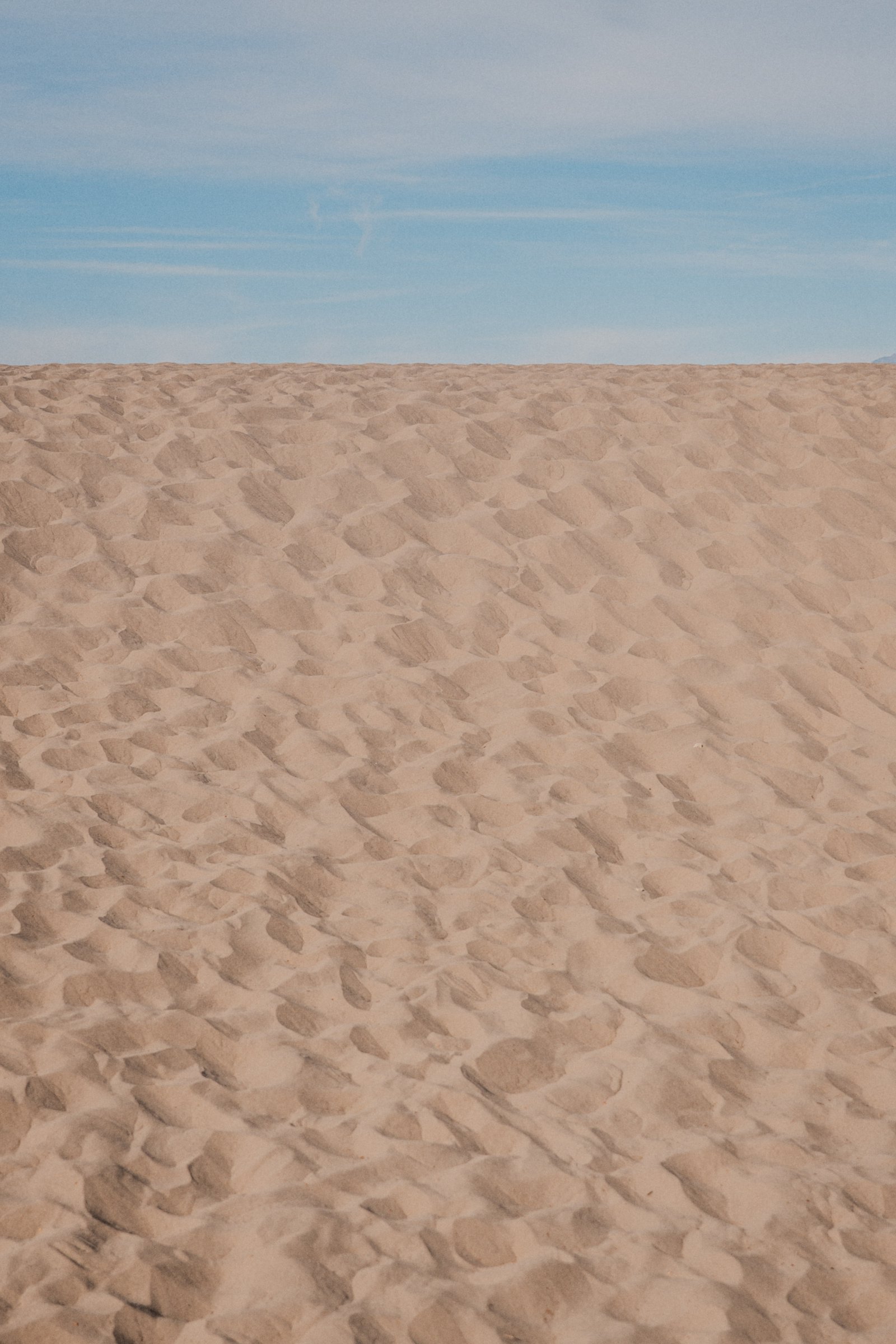 Wind-drawn ripples. The sand is always doing this as long as the wind blows.