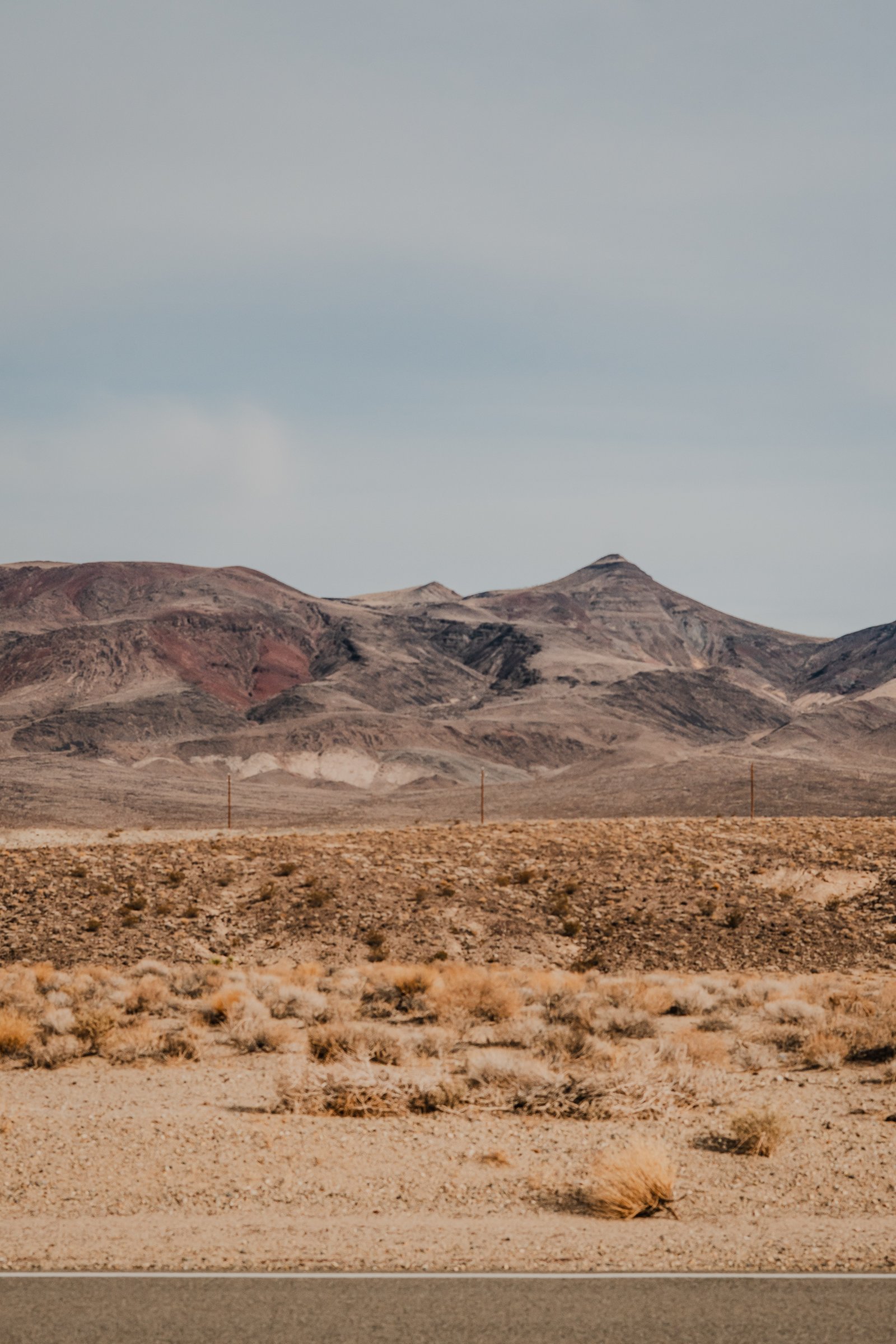 Valley floor and coloured mountains. The heat haze makes the far end of the valley look liquid.
