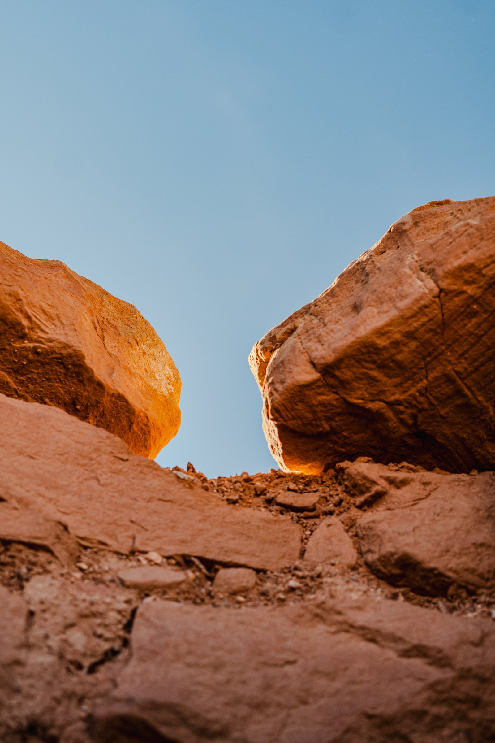 Looking up through the gap between two boulders at the canyon's edge. The sky reduced to a sliver.