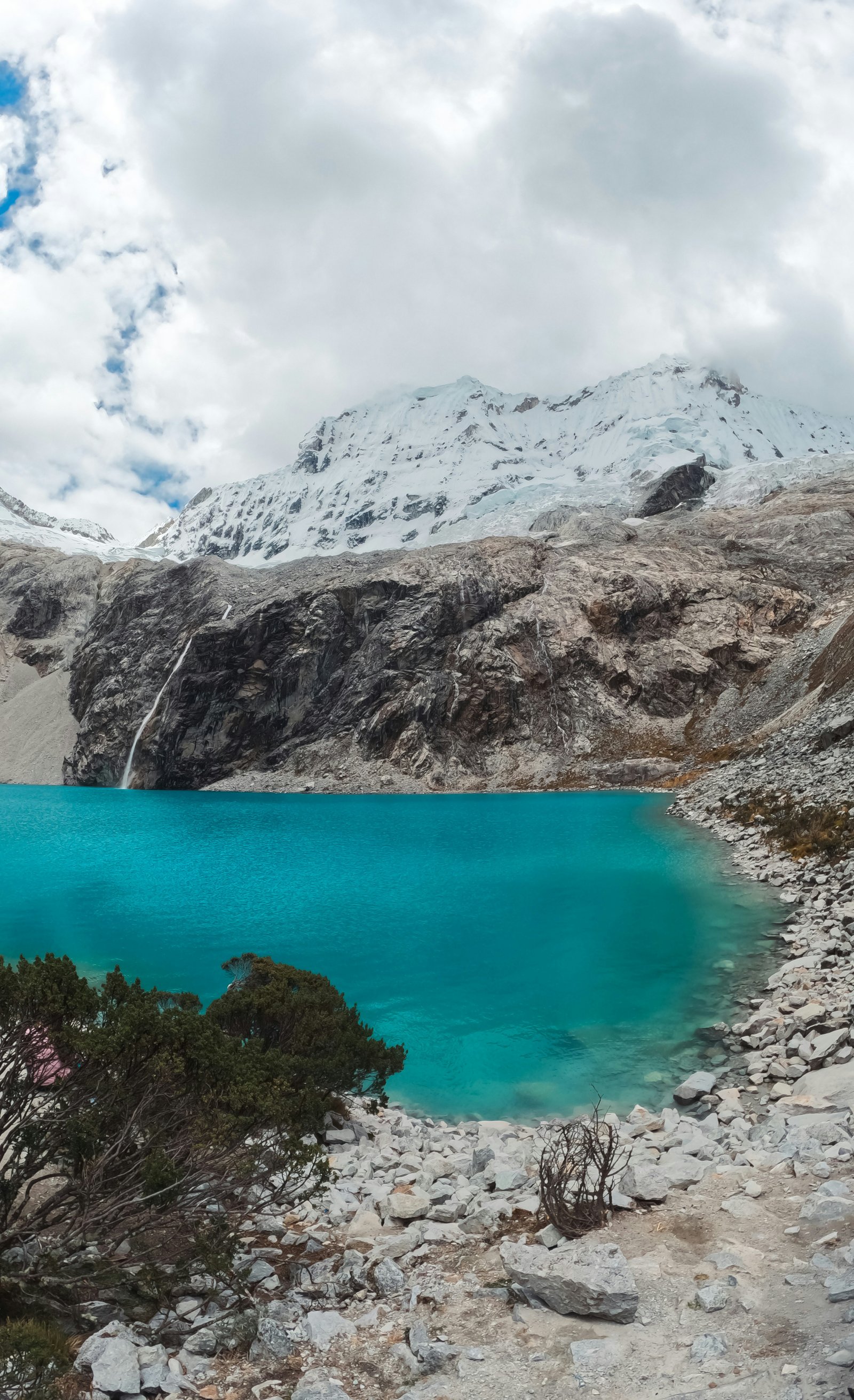 Laguna 69 from the rocky shoreline, Chopicalqui glacier and Cordillera Blanca peaks behind