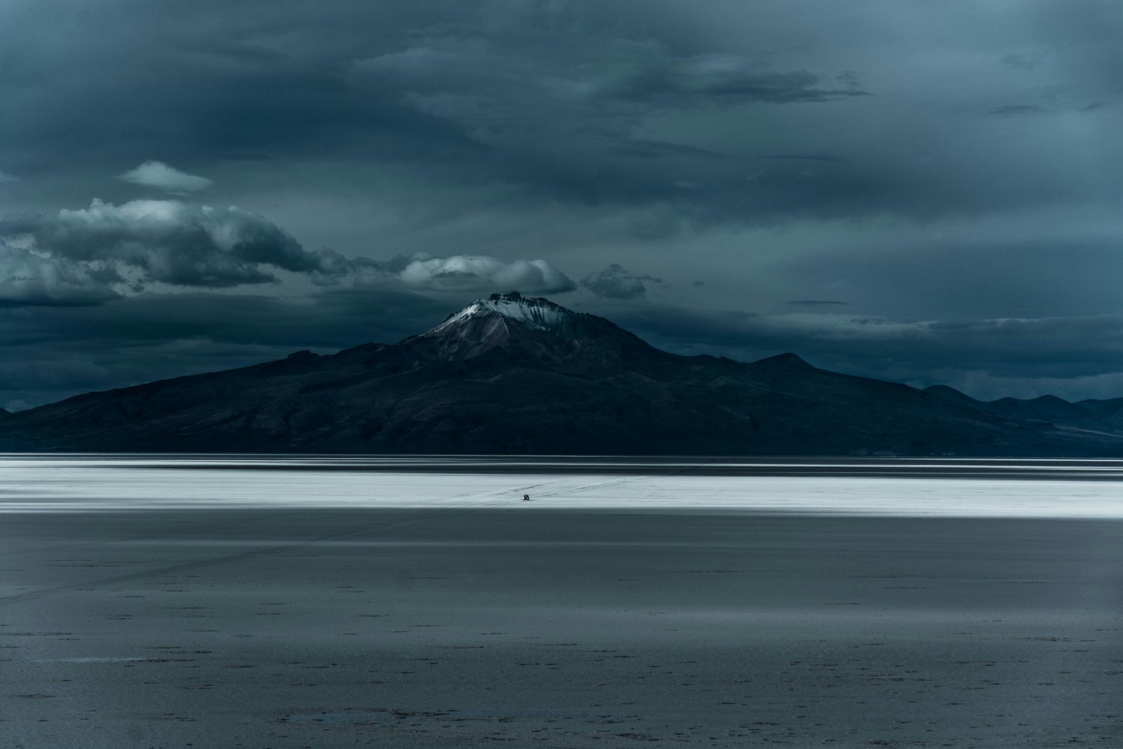White borax deposits on the shore of Laguna Colorada contrasting with red water