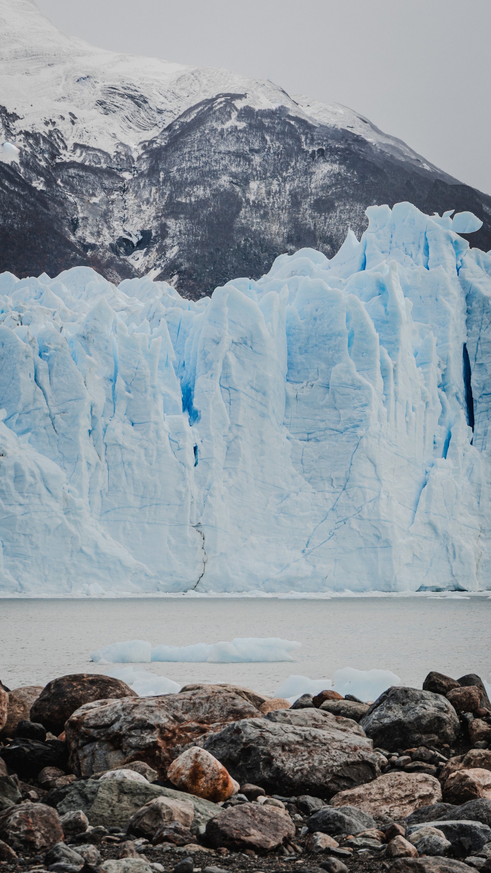 The ice wall at eye level. Blue veins of compressed air exposed.