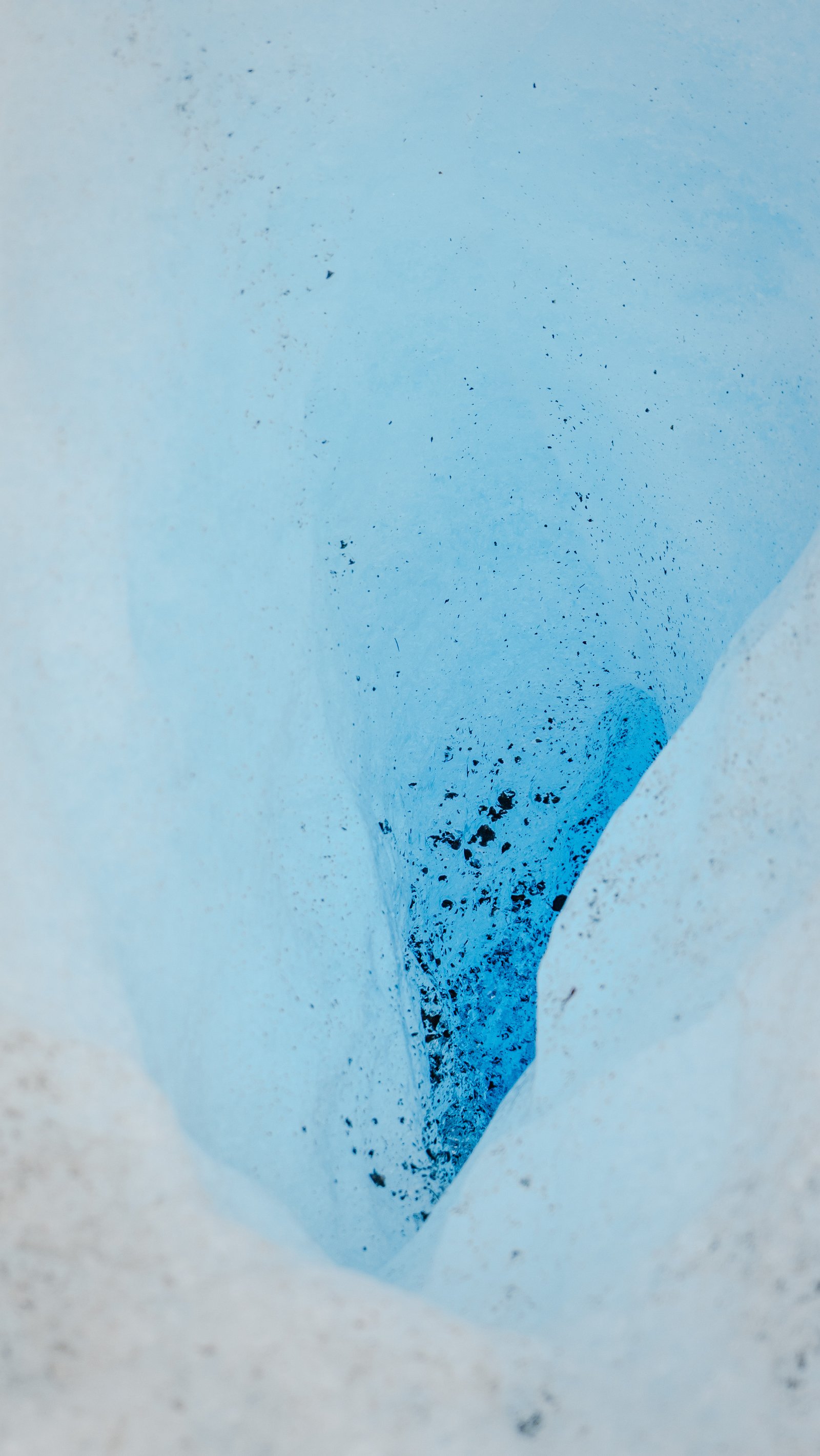 Looking into a crevasse from the rim. Ice chunks wedged at the base.
