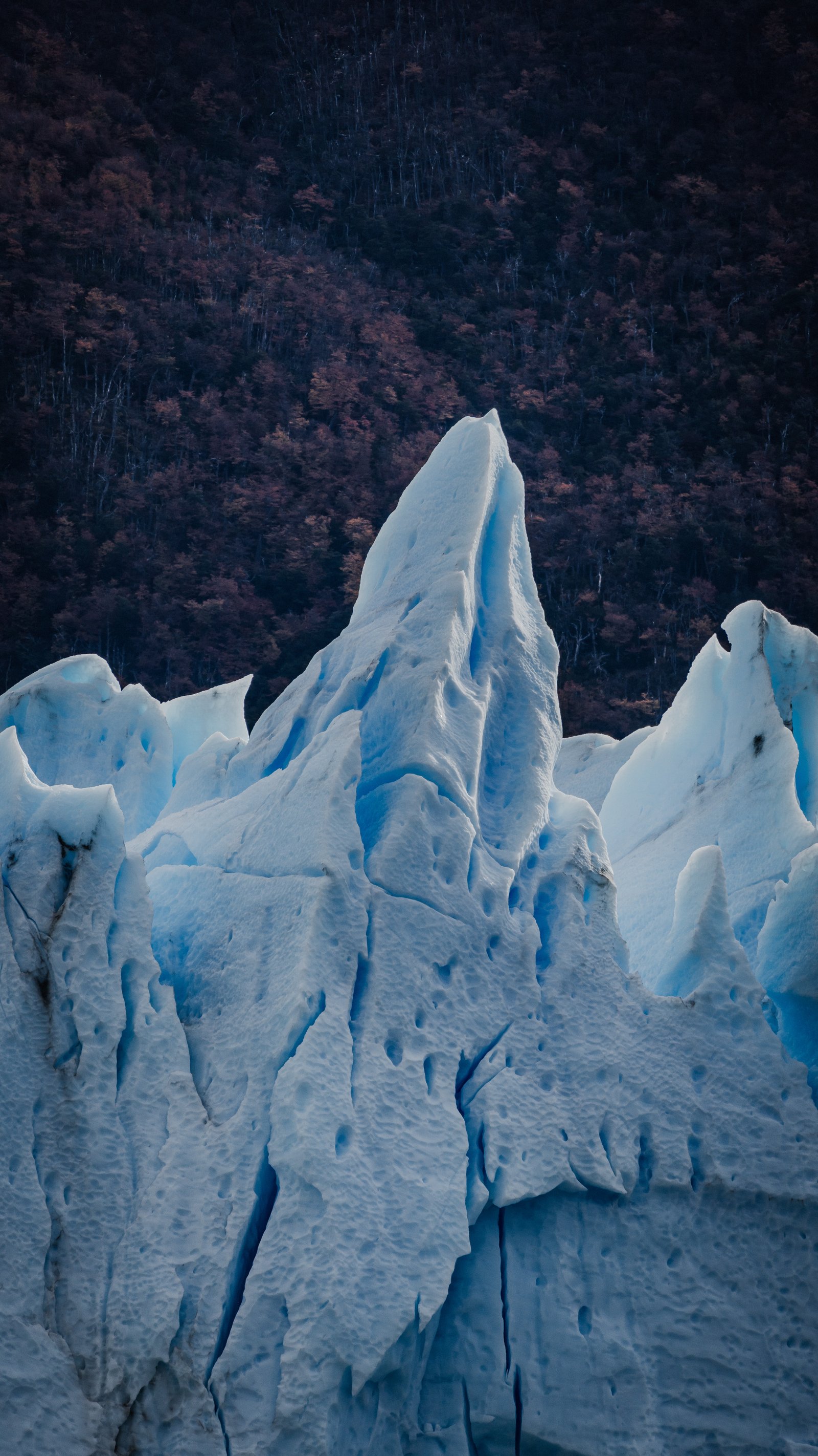 The glacier's jagged edge cutting across the Andean backdrop.