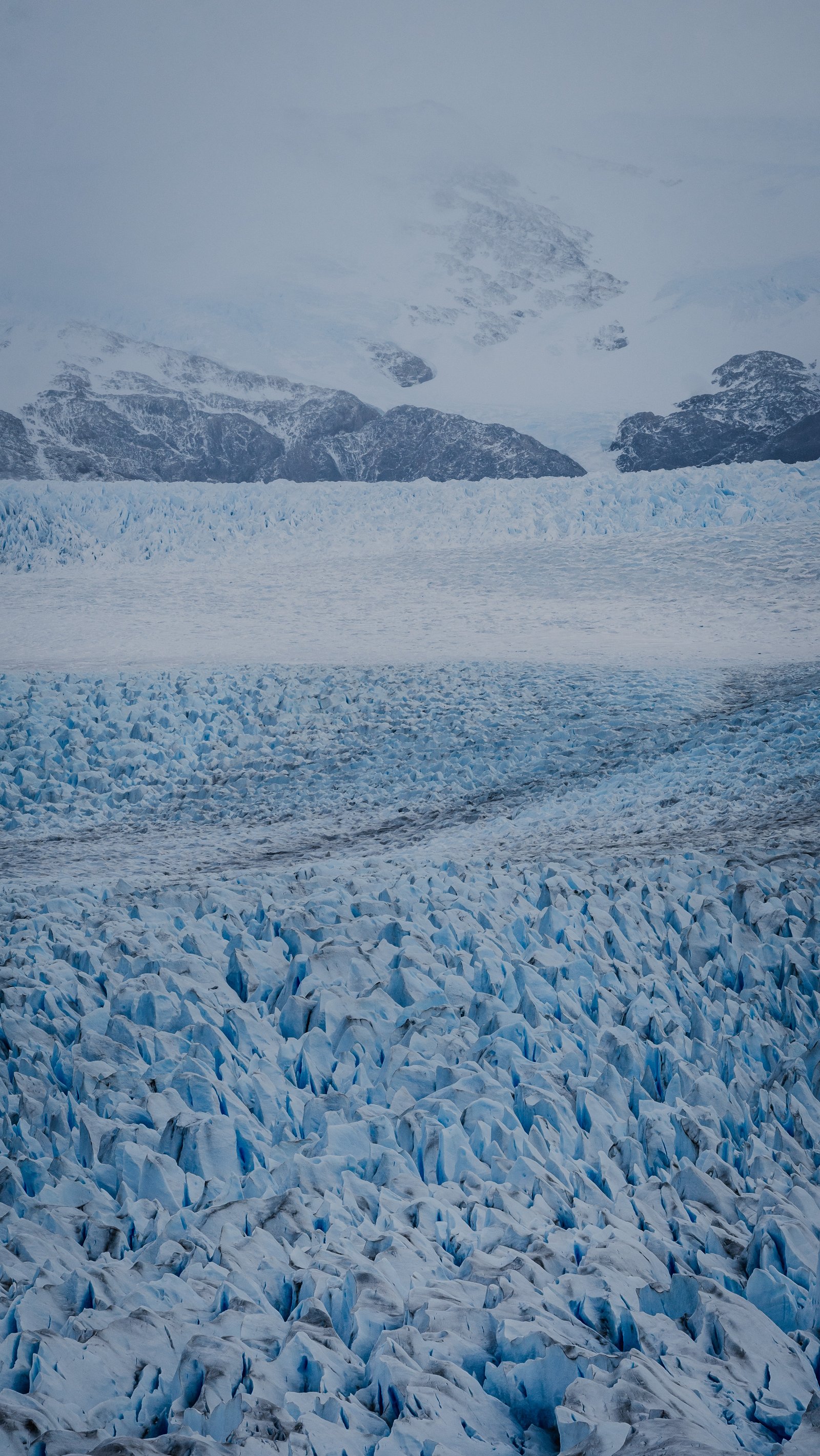 The two lobes of the glacier converging in fog