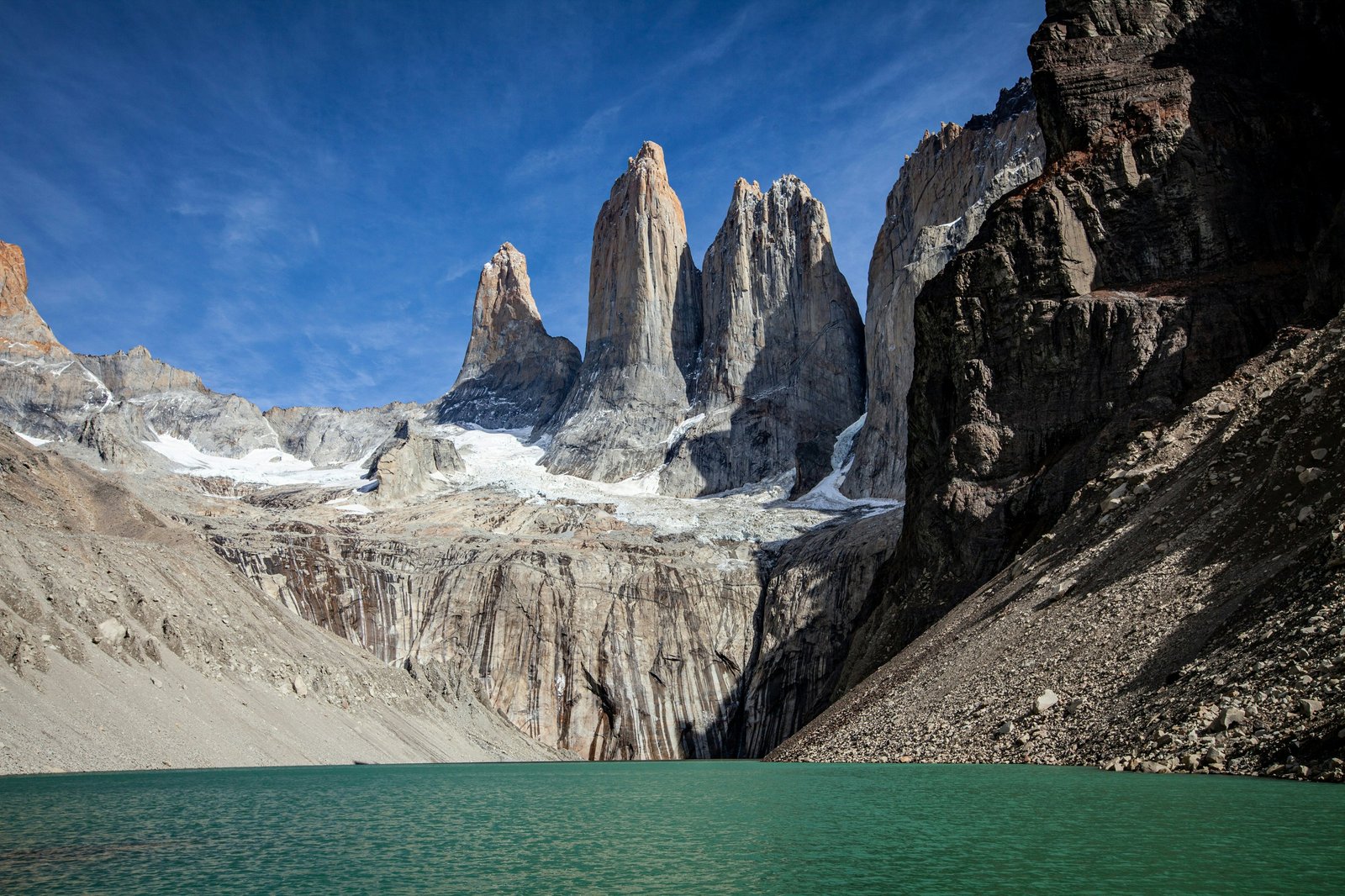 Las Torres rising above the mirador lake, granite spires and turquoise water under blue sky
