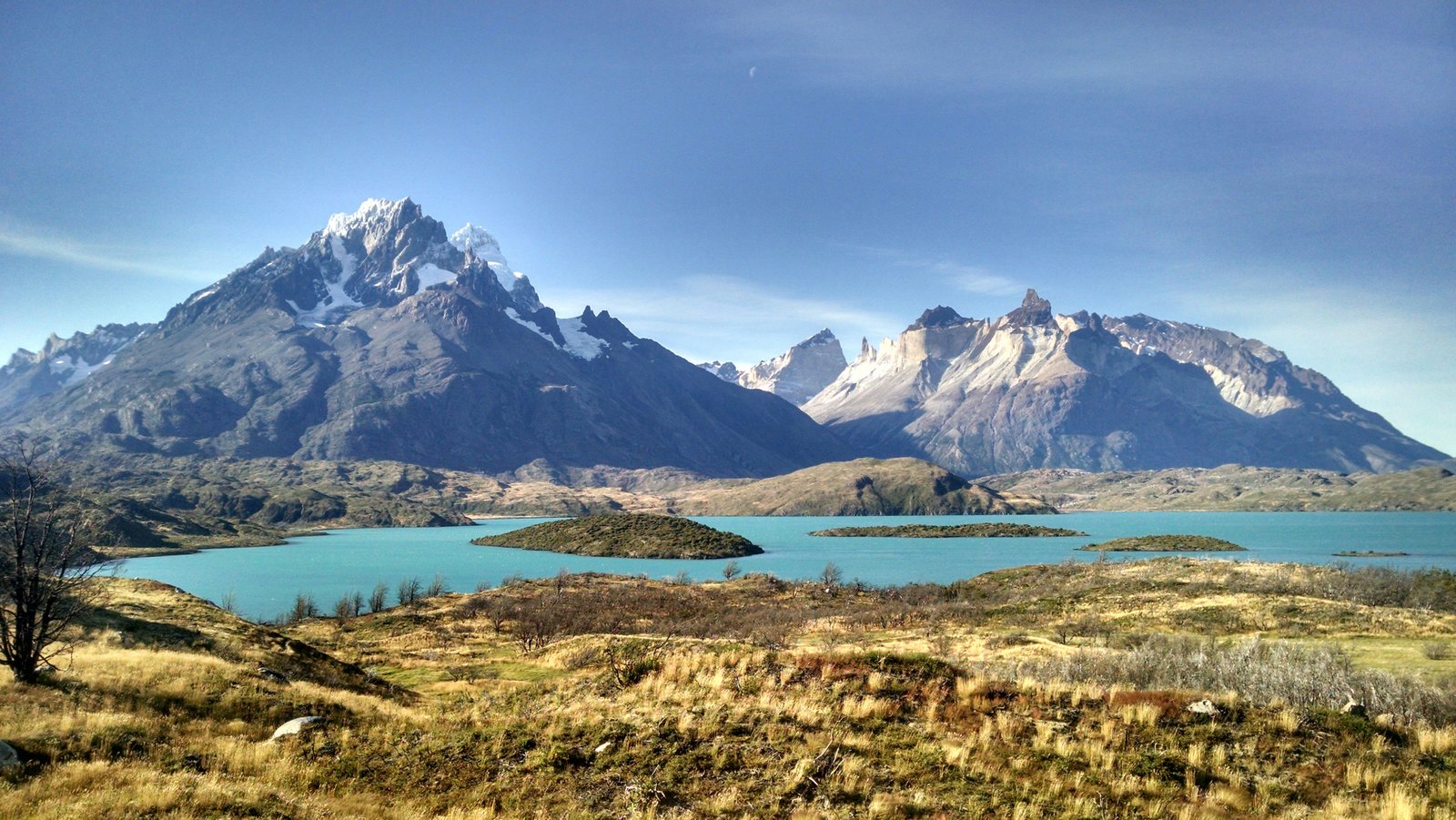 Lago Peho&eacute; turquoise water with Cuernos del Paine and Paine Grande under blue sky