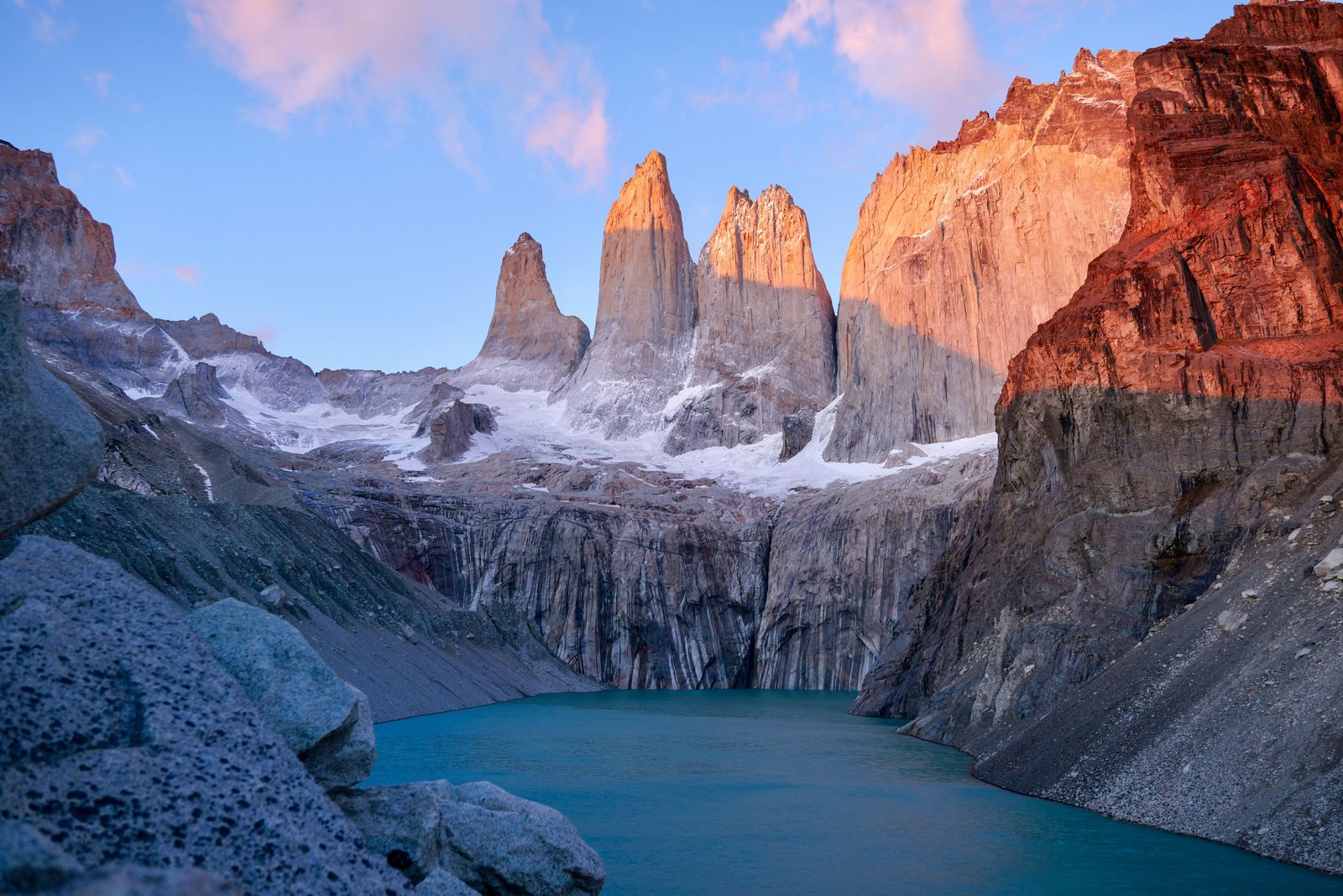 Las Torres at alpenglow, granite towers glowing orange at sunrise above the mirador lake