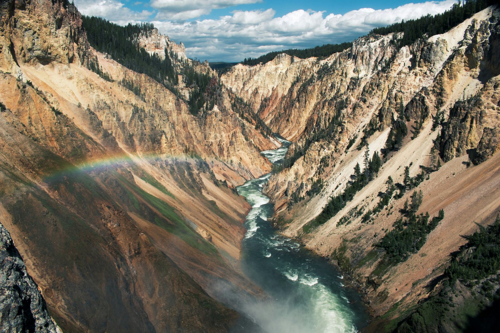 Grand Prismatic Spring aerial view with steam rising over rainbow mineral rings